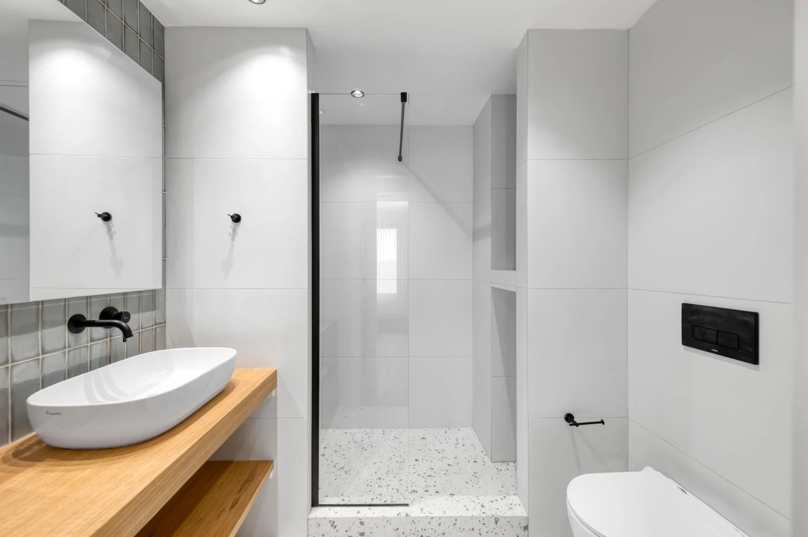 Bathroom with walk-in shower and wooden vanity at Dock 38