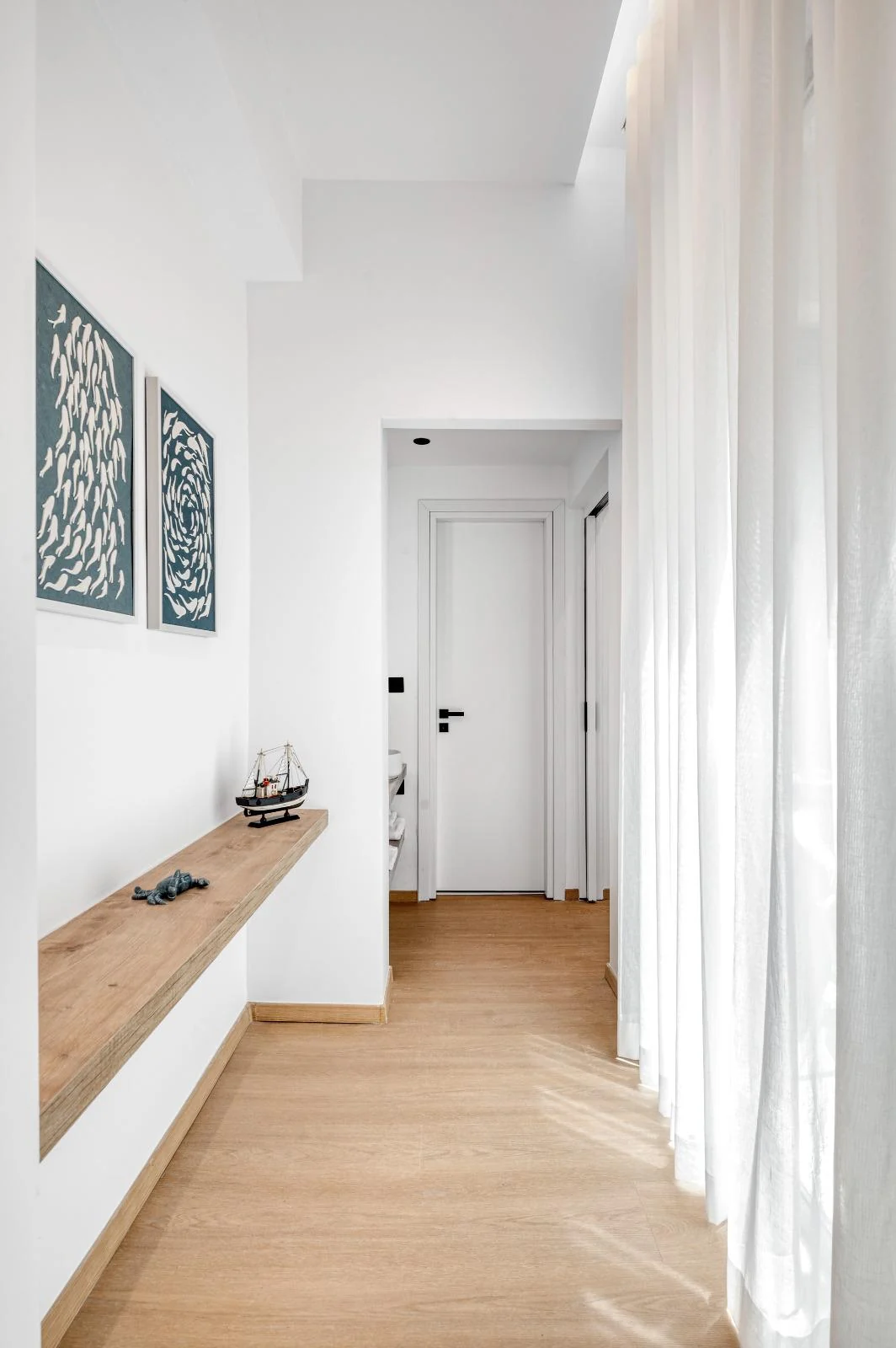 Sunlit interior hallway with maritime artwork at Dock 38