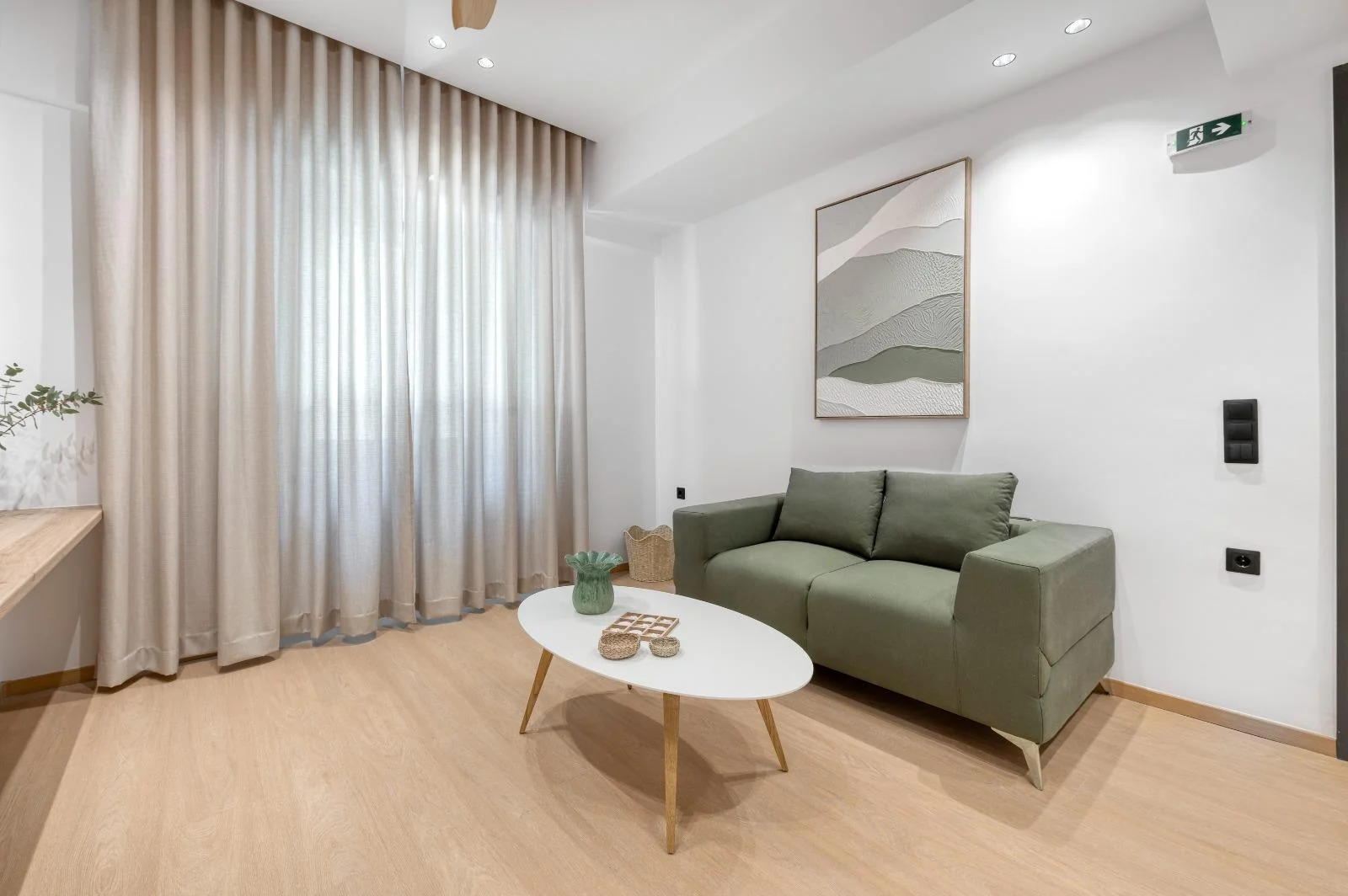 Living area with a green sofa and coffee table at Dock 38