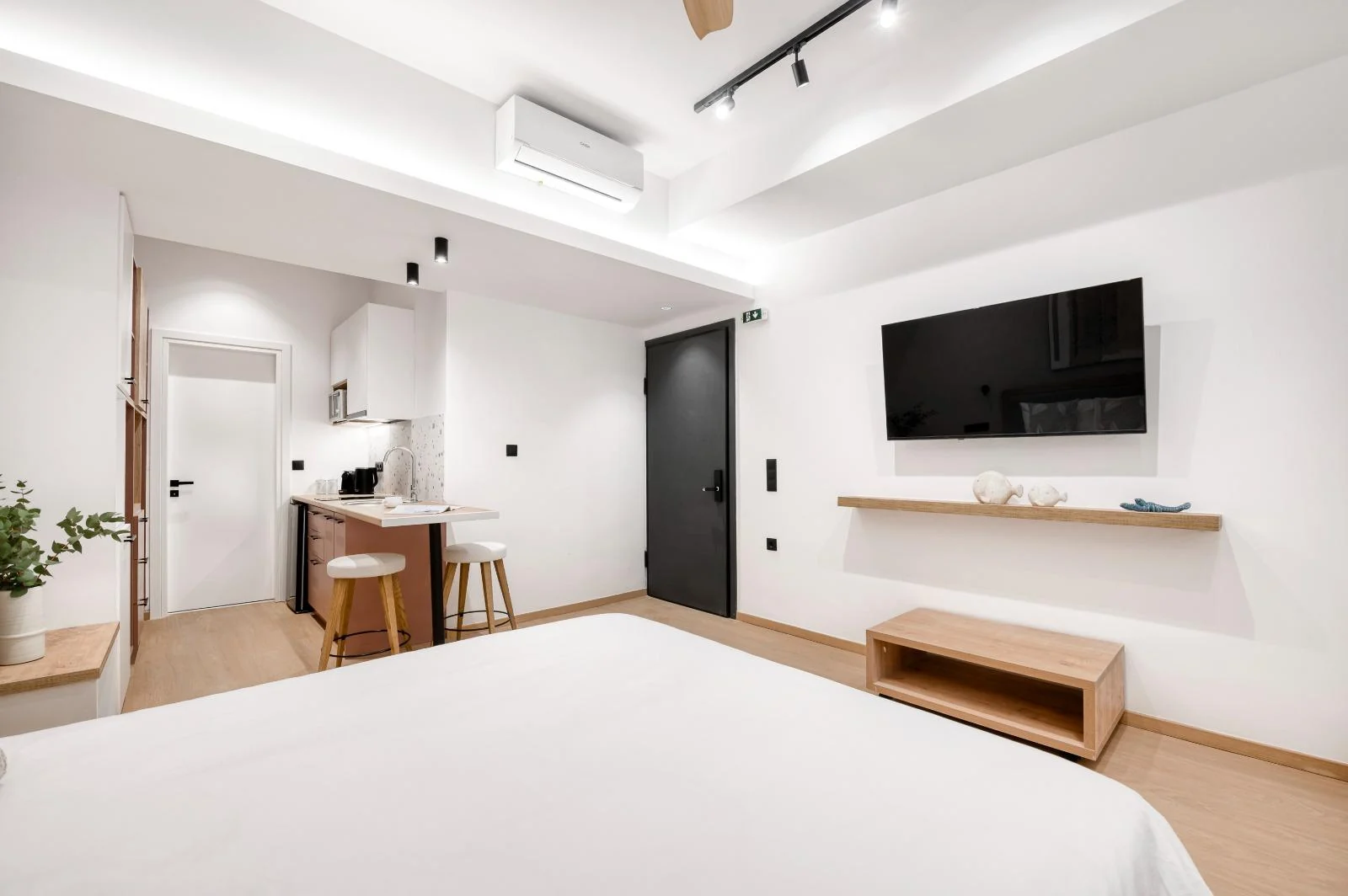 Studio sleeping area with kitchenette and television at Dock 38