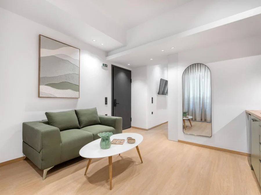 Dock 38 living area with a green sofa and kitchen