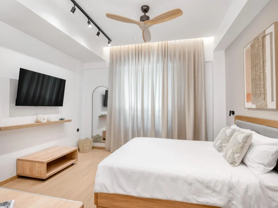 Dock 38 guest room with a large double bed and television