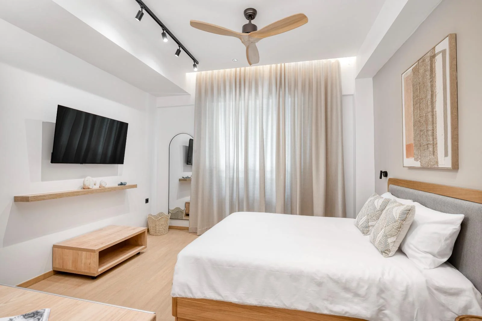 Dock 38 guest room with a large double bed and television